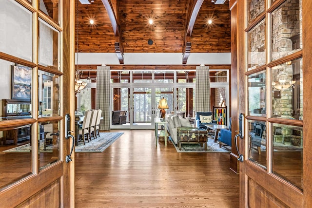 interior space with french doors, wood-type flooring, high vaulted ceiling, and beamed ceiling