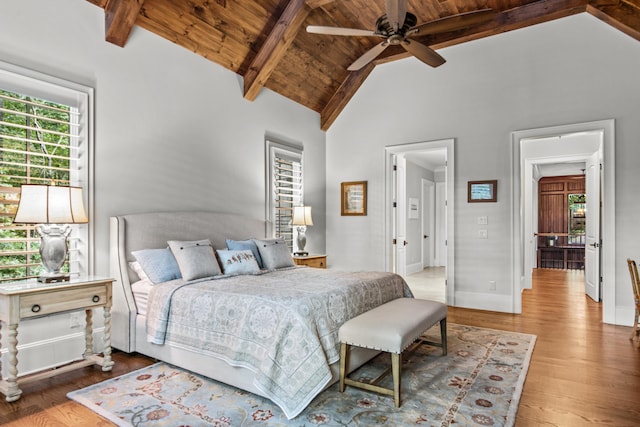 bedroom with beam ceiling, hardwood / wood-style floors, wood ceiling, and high vaulted ceiling