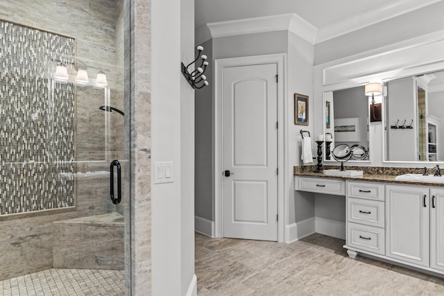 bathroom with ornamental molding, a shower with door, and vanity