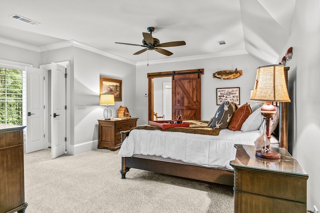 bedroom with ornamental molding, light colored carpet, a barn door, and ceiling fan