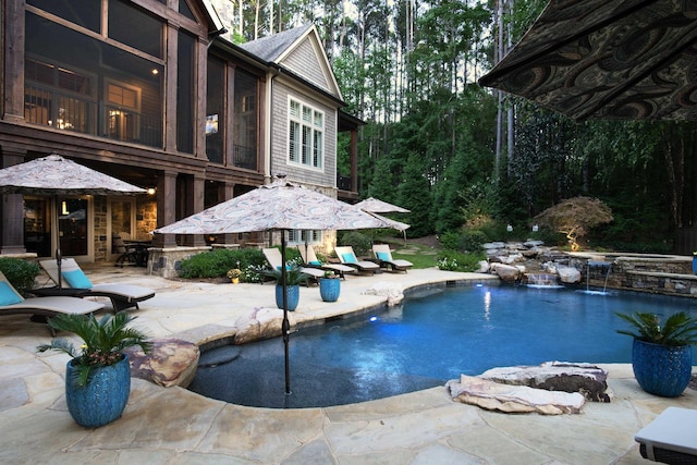 view of pool with pool water feature and a patio