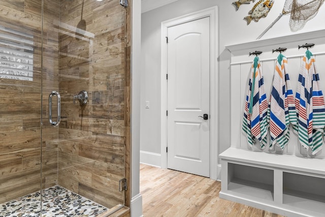 bathroom featuring wood-type flooring and a shower with door