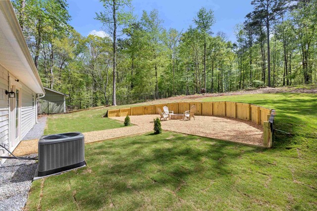 348 Bluegill Rd, Eatonton, GA 31024 - view of yard with central air condition unit, a patio area, fence, and a forest view