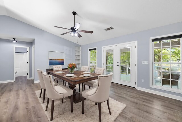 348 Bluegill Rd, Eatonton, GA 31024 - dining area with built in features, visible vents, vaulted ceiling, wood finished floors, and baseboards