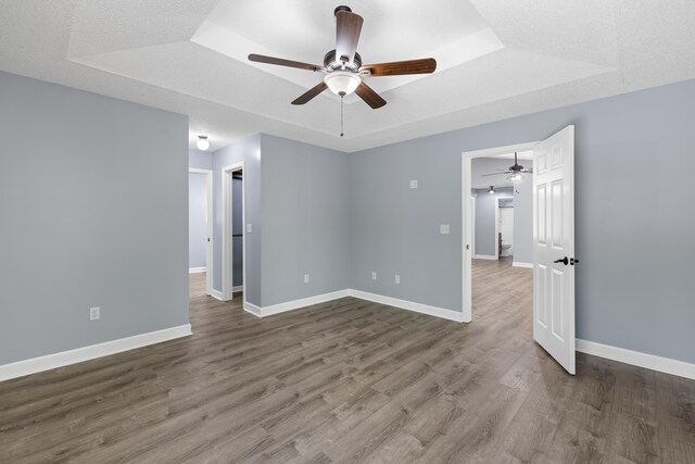 348 Bluegill Rd, Eatonton, GA 31024 - unfurnished room with a tray ceiling, ceiling fan, wood finished floors, and baseboards
