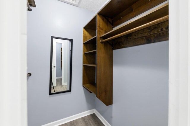 348 Bluegill Rd, Eatonton, GA 31024 - bathroom with a bath, baseboards, curtained shower, a textured ceiling, and wood finished floors