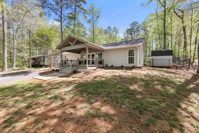 348 Bluegill Rd, Eatonton, GA 31024 - view of front of house with a ceiling fan, french doors, fence, and roof with shingles