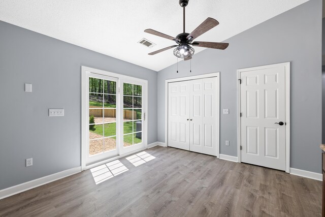 348 Bluegill Rd, Eatonton, GA 31024 - unfurnished bedroom with visible vents, baseboards, a closet, wood finished floors, and vaulted ceiling