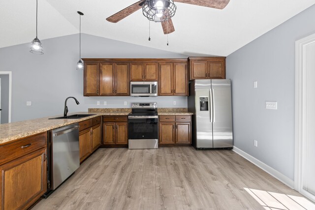 348 Bluegill Rd, Eatonton, GA 31024 - kitchen featuring vaulted ceiling, brown cabinetry, ceiling fan, stainless steel appliances, and a sink