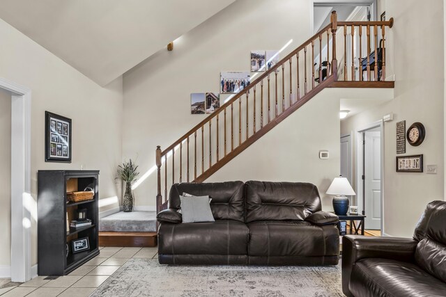 living room featuring light tile patterned floors and high vaulted ceiling