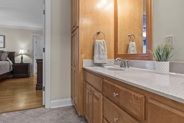 bathroom featuring crown molding, vanity, and tile patterned flooring