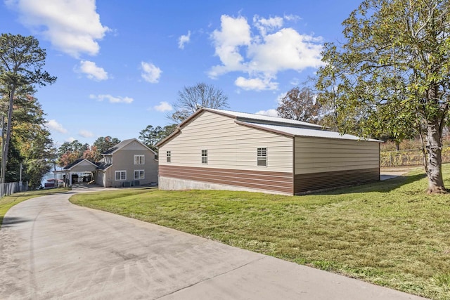 view of side of home with a lawn