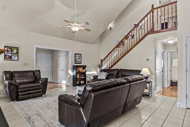 living room with ceiling fan, light tile patterned floors, and high vaulted ceiling