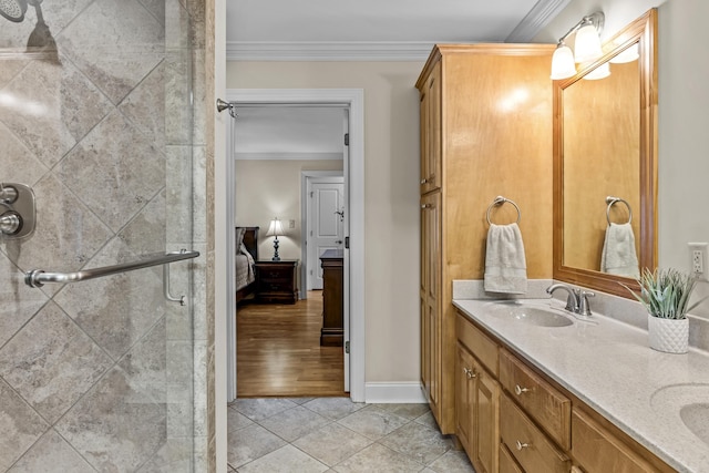 bathroom with an enclosed shower, vanity, crown molding, and tile patterned floors