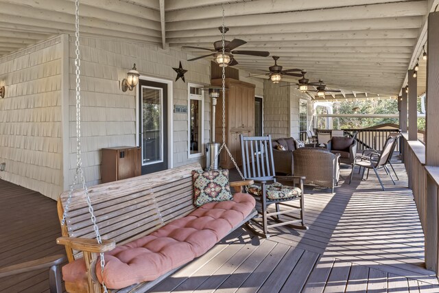 wooden terrace featuring ceiling fan