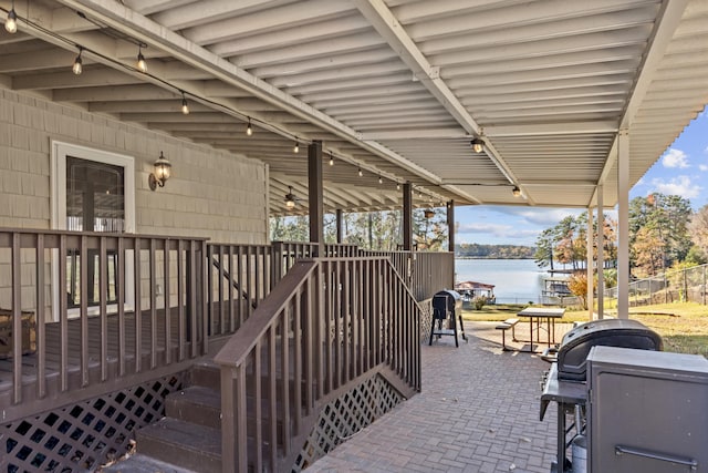 view of patio / terrace with a deck with water view