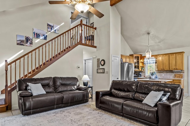 tiled living room with beam ceiling, ceiling fan with notable chandelier, and high vaulted ceiling