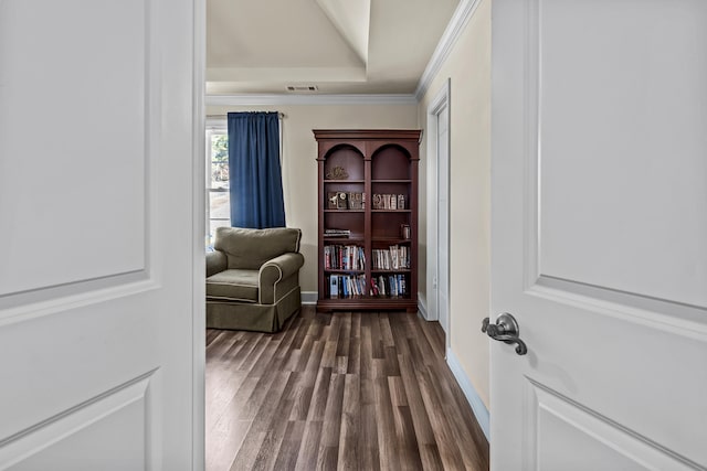 sitting room featuring crown molding, a tray ceiling, and dark hardwood / wood-style flooring