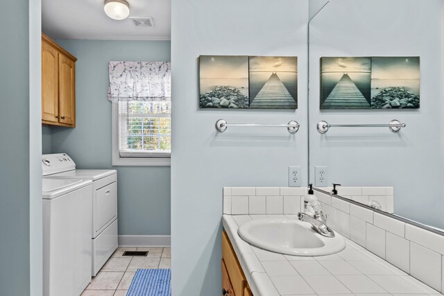 bathroom with tile patterned floors, vanity, and washer and dryer