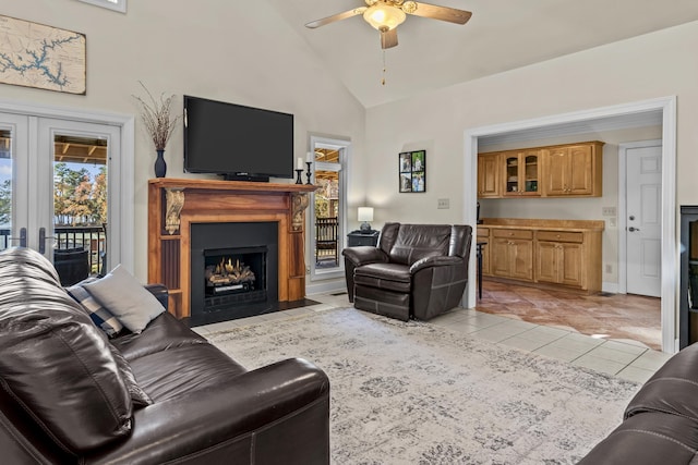 tiled living room featuring high vaulted ceiling and ceiling fan