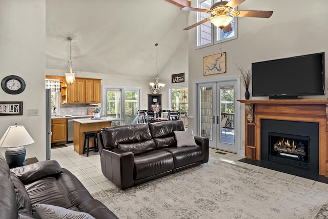 living room with light tile patterned flooring, ceiling fan, high vaulted ceiling, and french doors