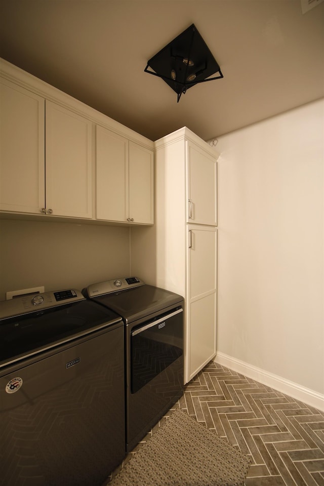 1060 Legend Dr, Greensboro, GA 30642 - washroom with cabinet space, washing machine and dryer, and brick patterned flooring