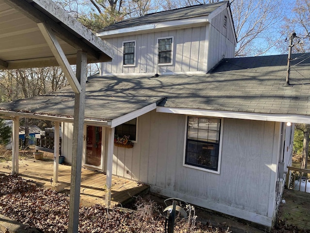 rear view of property featuring a wooden deck