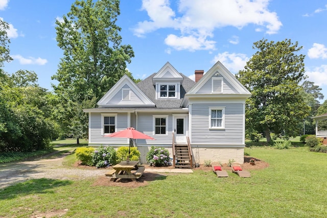 406 Madison Ave, Eatonton, GA 31024 - view of front of home with a front lawn, a chimney, and a shingled roof