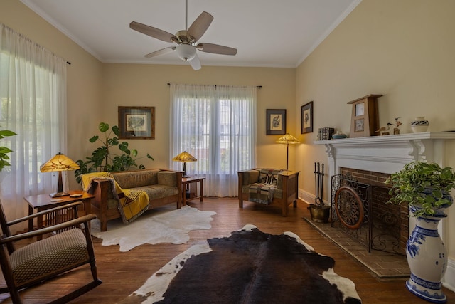 406 Madison Ave, Eatonton, GA 31024 - living area featuring wood finished floors, ceiling fan, ornamental molding, a brick fireplace, and baseboards