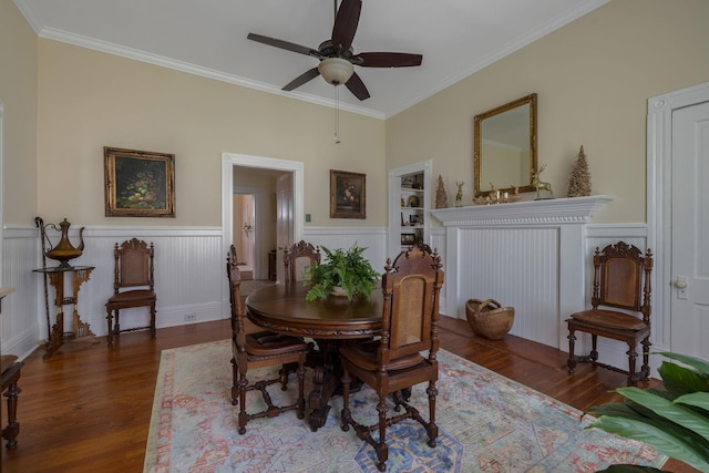 406 Madison Ave, Eatonton, GA 31024 - dining room with wood finished floors, ceiling fan, built in features, crown molding, and a wainscoted wall