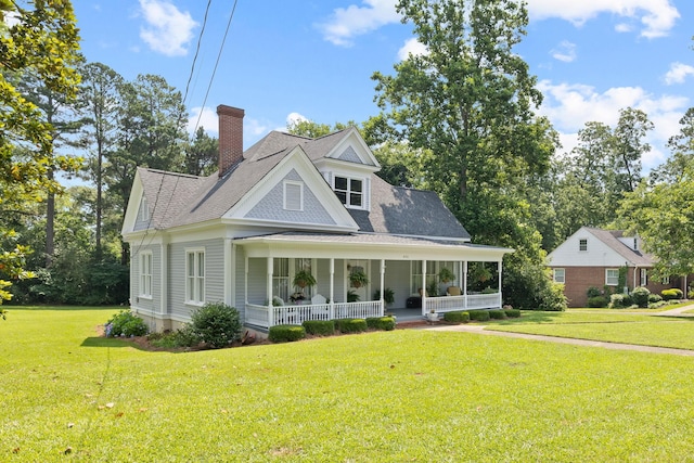 406 Madison Ave, Eatonton, GA 31024 - view of front of property featuring a porch, a chimney, a front lawn, and a shingled roof