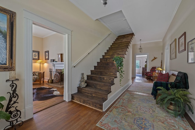 406 Madison Ave, Eatonton, GA 31024 - stairway with wood finished floors, crown molding, and a fireplace