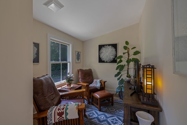 406 Madison Ave, Eatonton, GA 31024 - living area featuring vaulted ceiling, wood finished floors, and baseboards