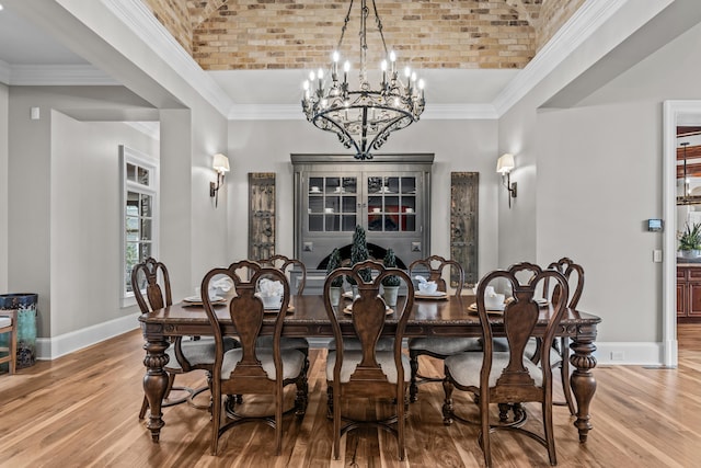 dining room with hardwood / wood-style flooring, brick ceiling, and crown molding