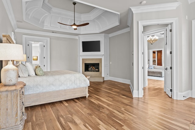 bedroom with crown molding, hardwood / wood-style flooring, coffered ceiling, and a chandelier