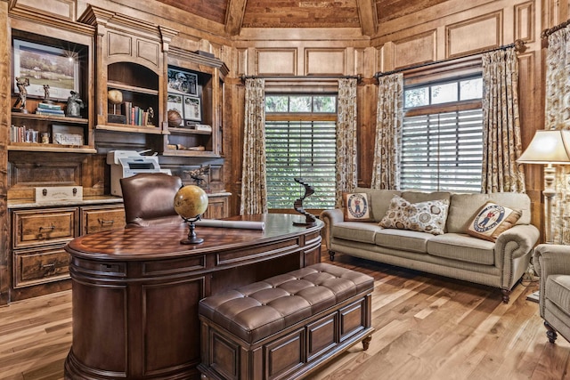 office space featuring light hardwood / wood-style floors and wood walls