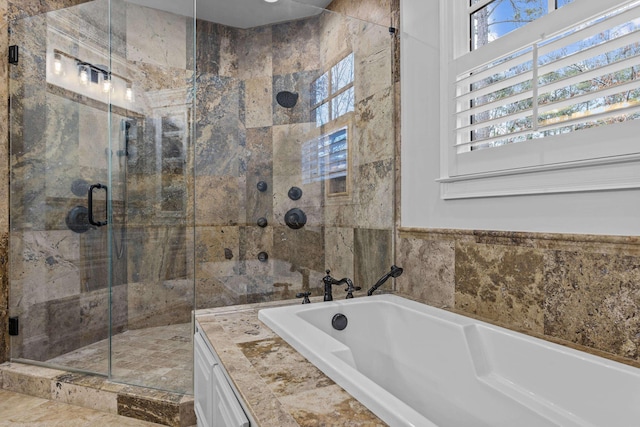 bathroom featuring separate shower and tub