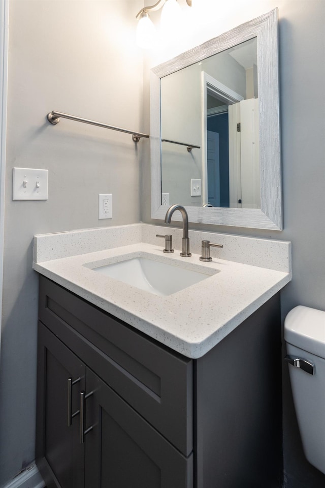 bathroom featuring vanity and toilet