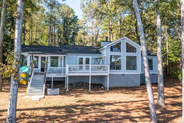 back of property with a deck and french doors