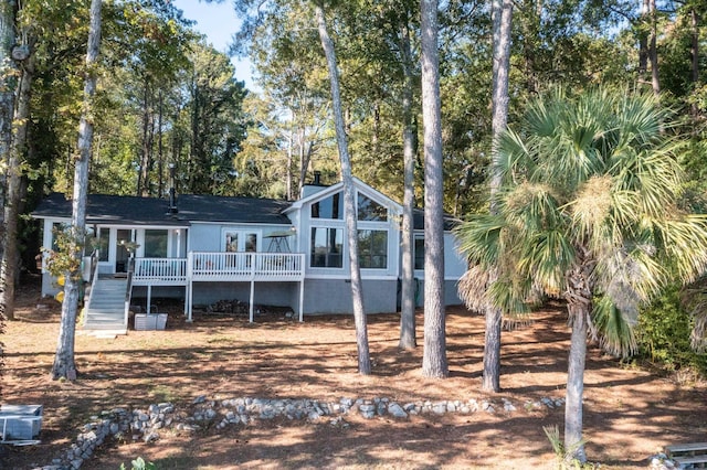 rear view of property with a wooden deck