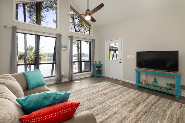 living room with ceiling fan, high vaulted ceiling, and dark hardwood / wood-style flooring