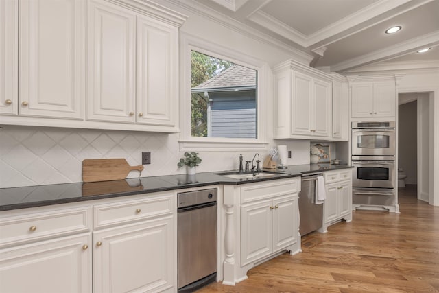 kitchen with white cabinetry, sink, stainless steel appliances, crown molding, and light wood-type flooring