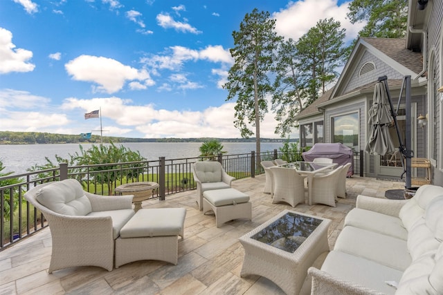 view of patio with outdoor lounge area and a water view
