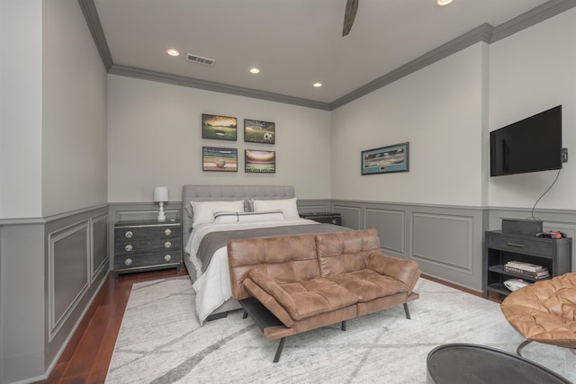 bedroom with crown molding, ceiling fan, and dark hardwood / wood-style flooring