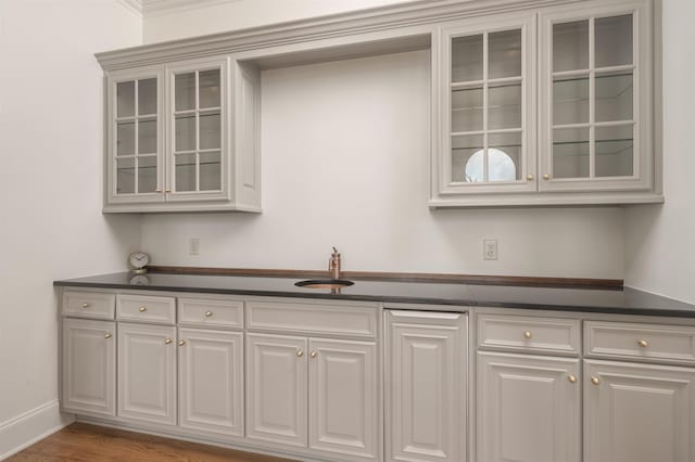 bar with sink and hardwood / wood-style flooring