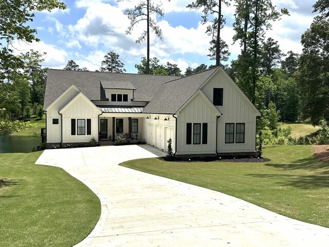 modern farmhouse style home featuring a garage, a front yard, and a porch