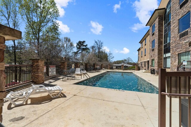 view of swimming pool with a patio