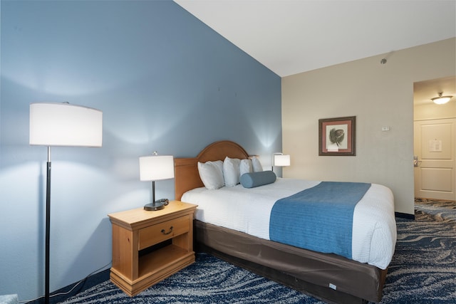 carpeted bedroom with vaulted ceiling