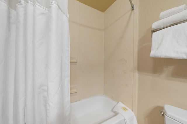 bathroom with shower / bath combo and toilet