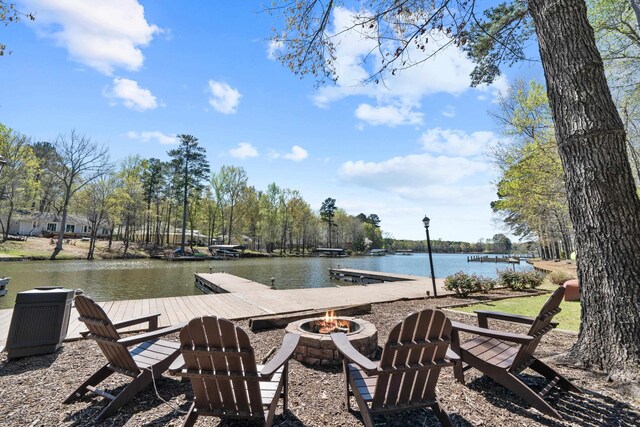 view of dock with a water view and an outdoor fire pit